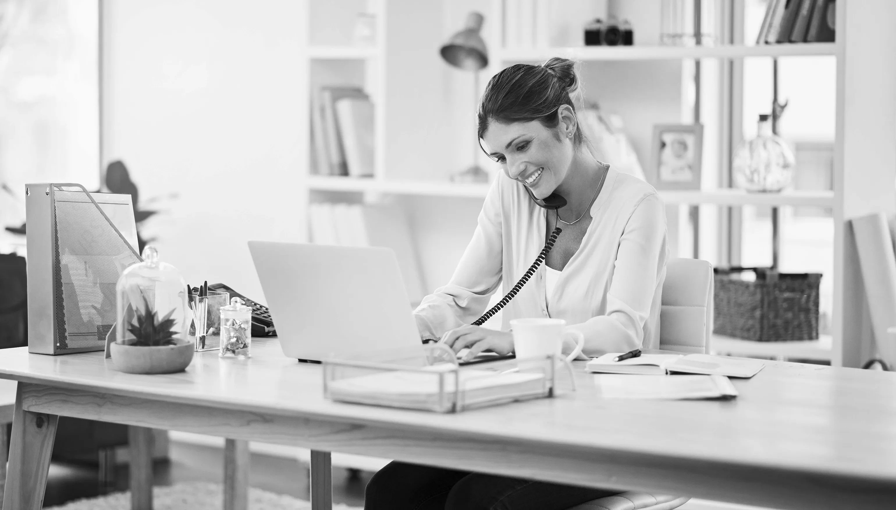 Woman working on laptop computer in home office